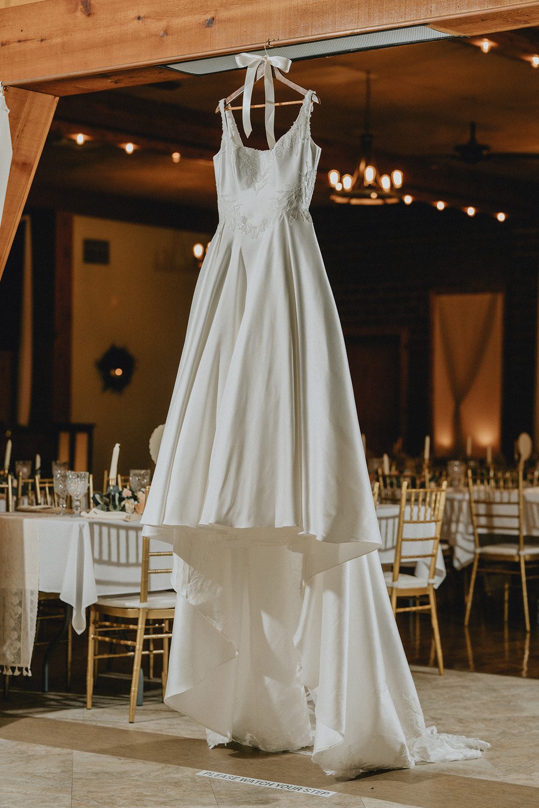 Wedding dress hanging by the window