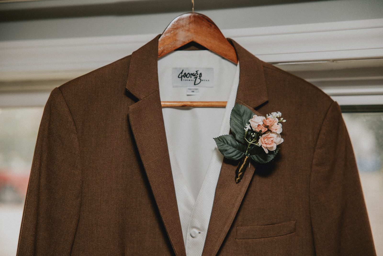 Groom's brown jacket with boutonniere
