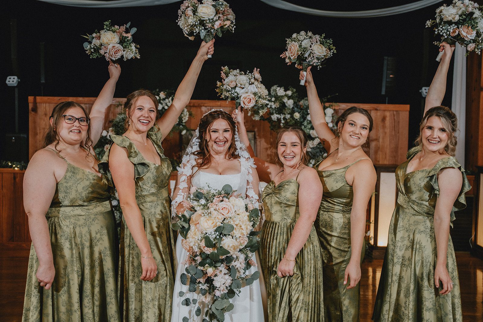 Bridesmaids cheering with the bride
