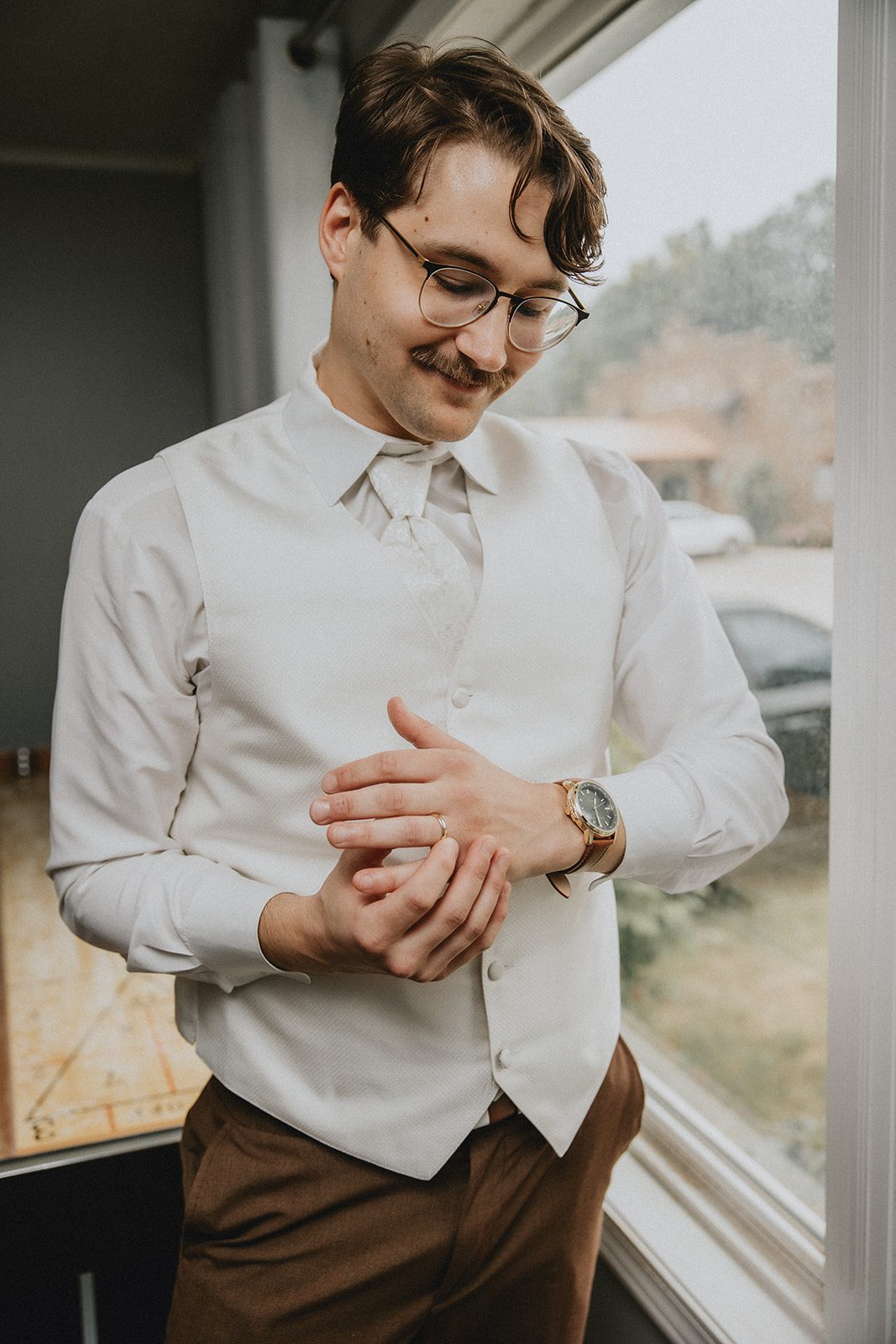 Groom getting ready in his vest