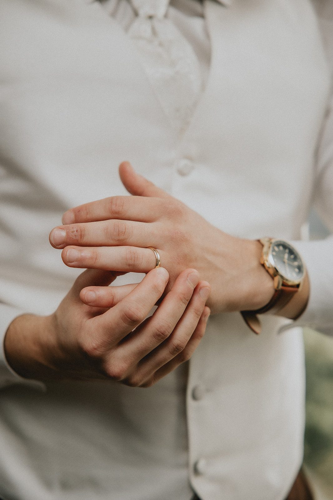 Close up of the groom's hands and ring