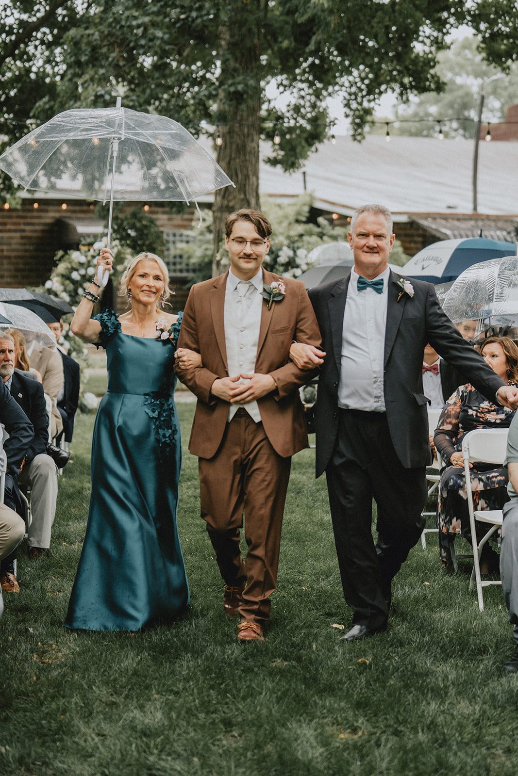 Wedding party walking down the garden aisle