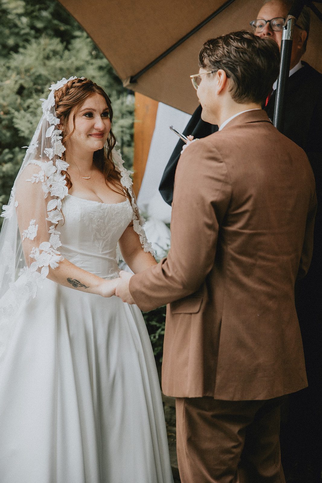 Couple holding hands at the ceremony
