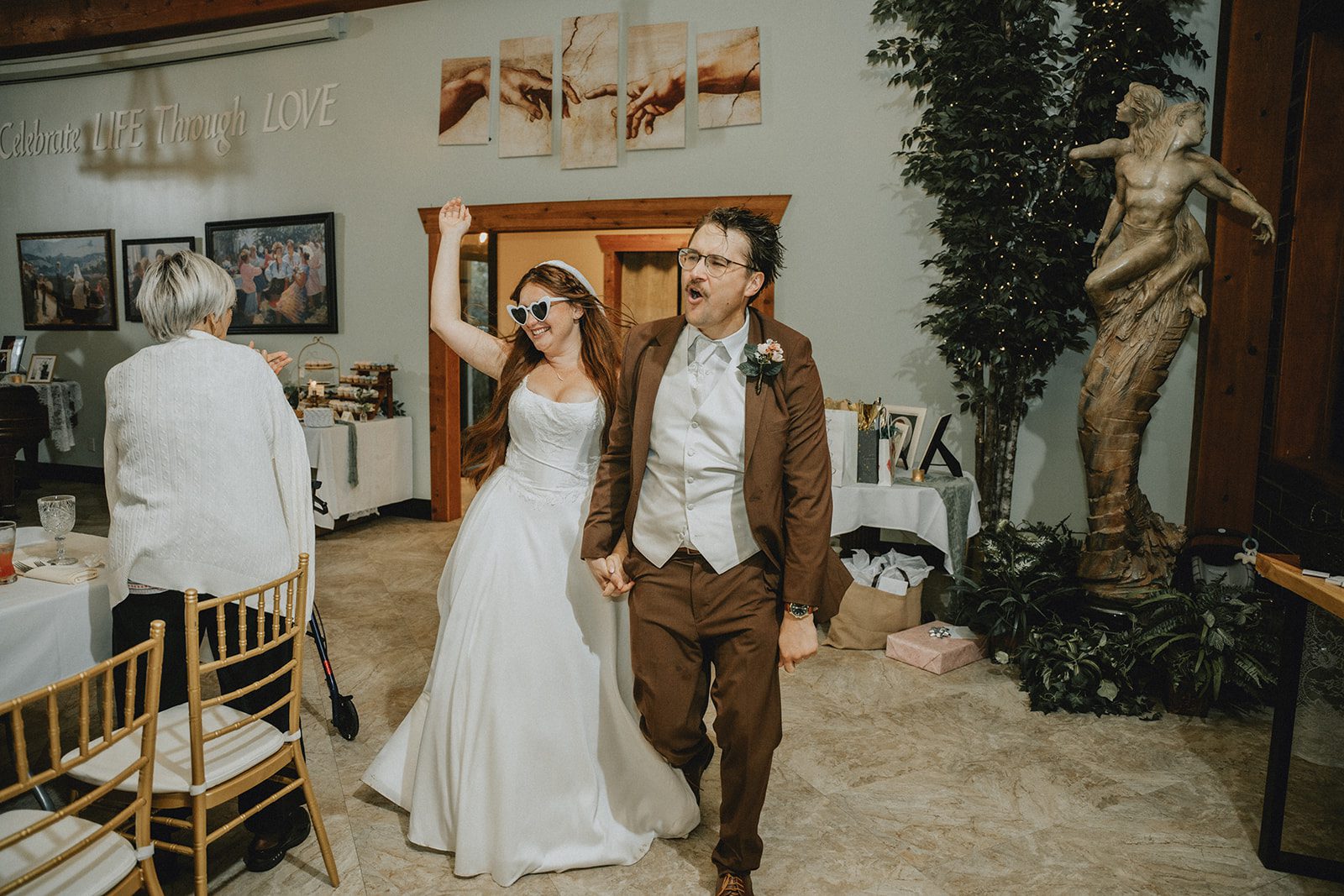 Couple celebrating as they enter the reception