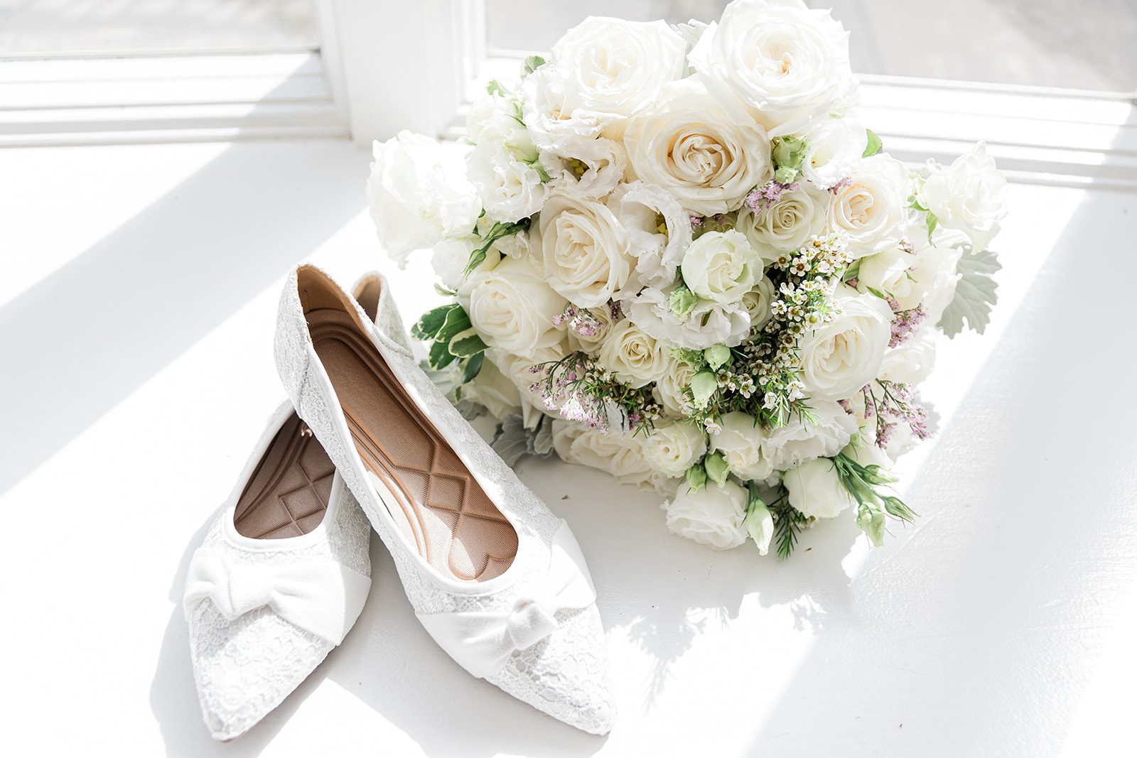 Bridal shoes with a white bouquet Bridal shoes with a white bouquet