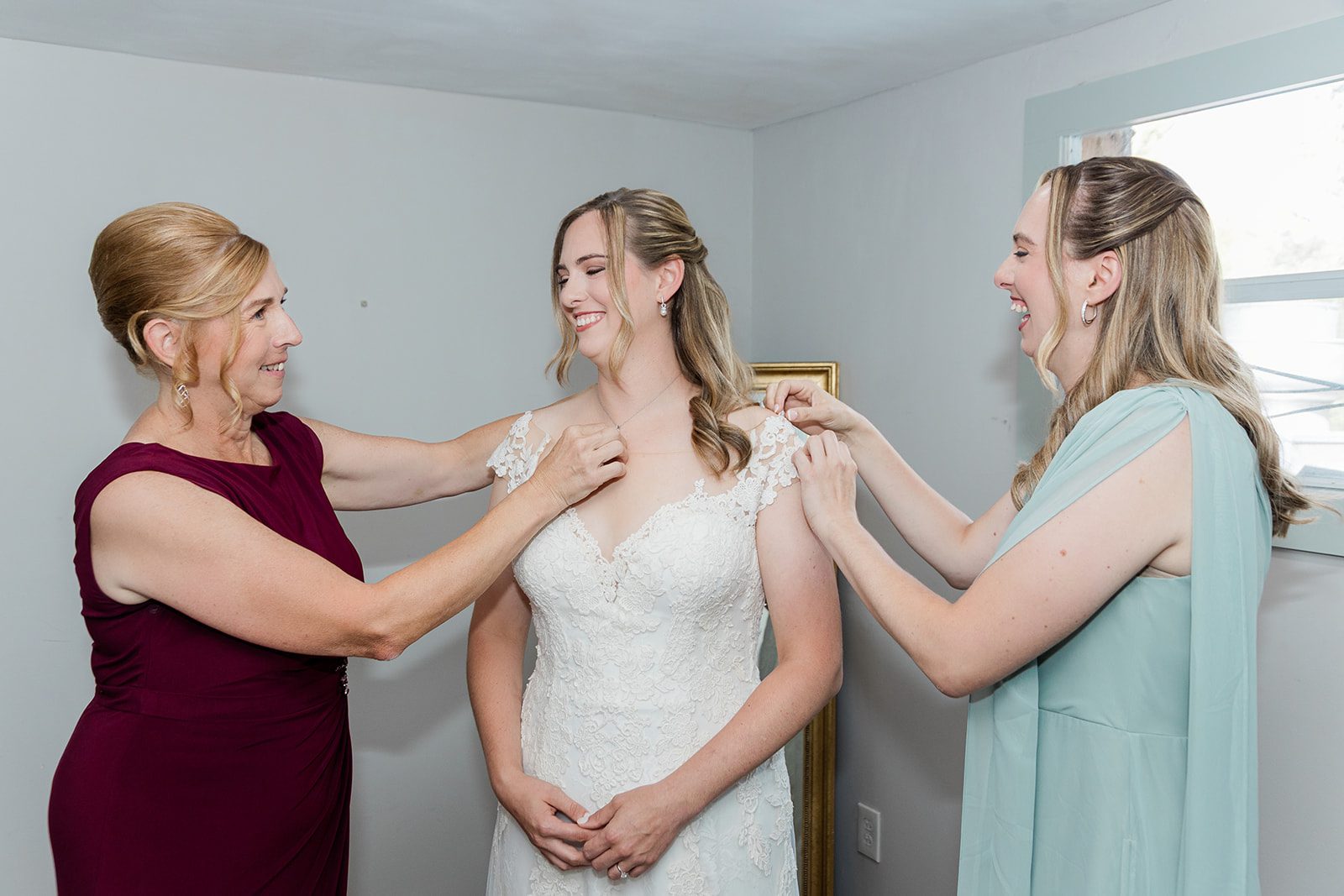 Bride getting into her gown with help Bride getting into her gown with help