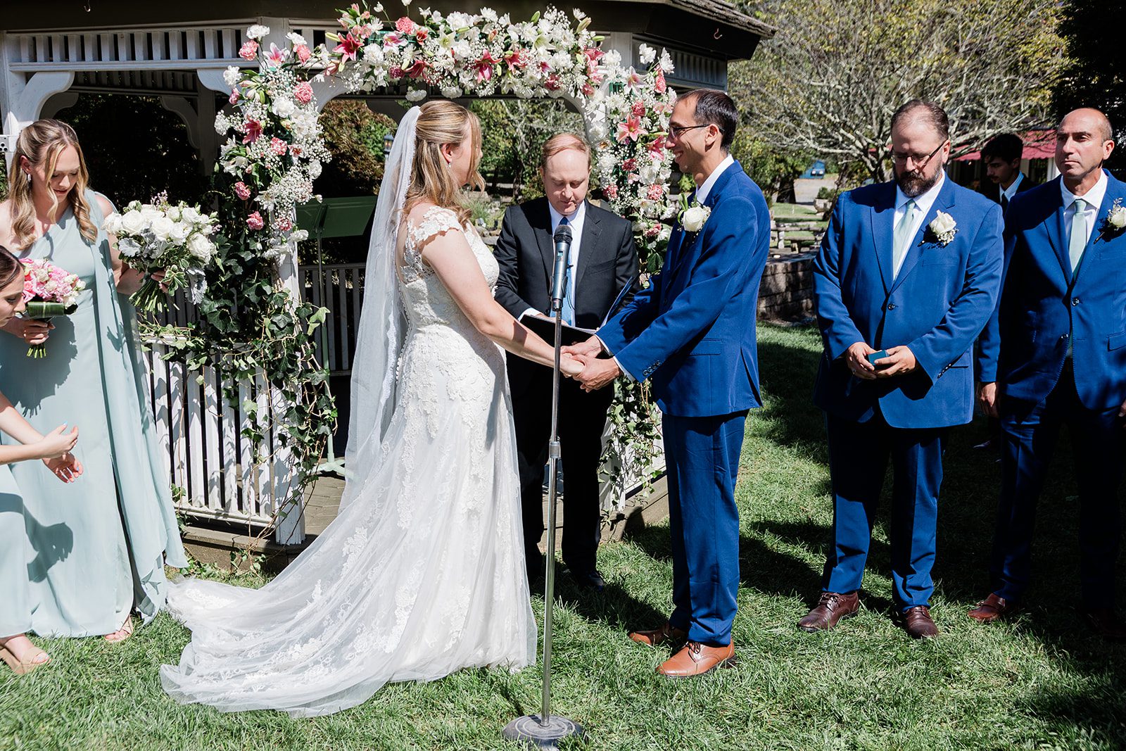 Ceremony under the floral arch at Travelers Rest Ceremony under the floral arch at Travelers Rest
