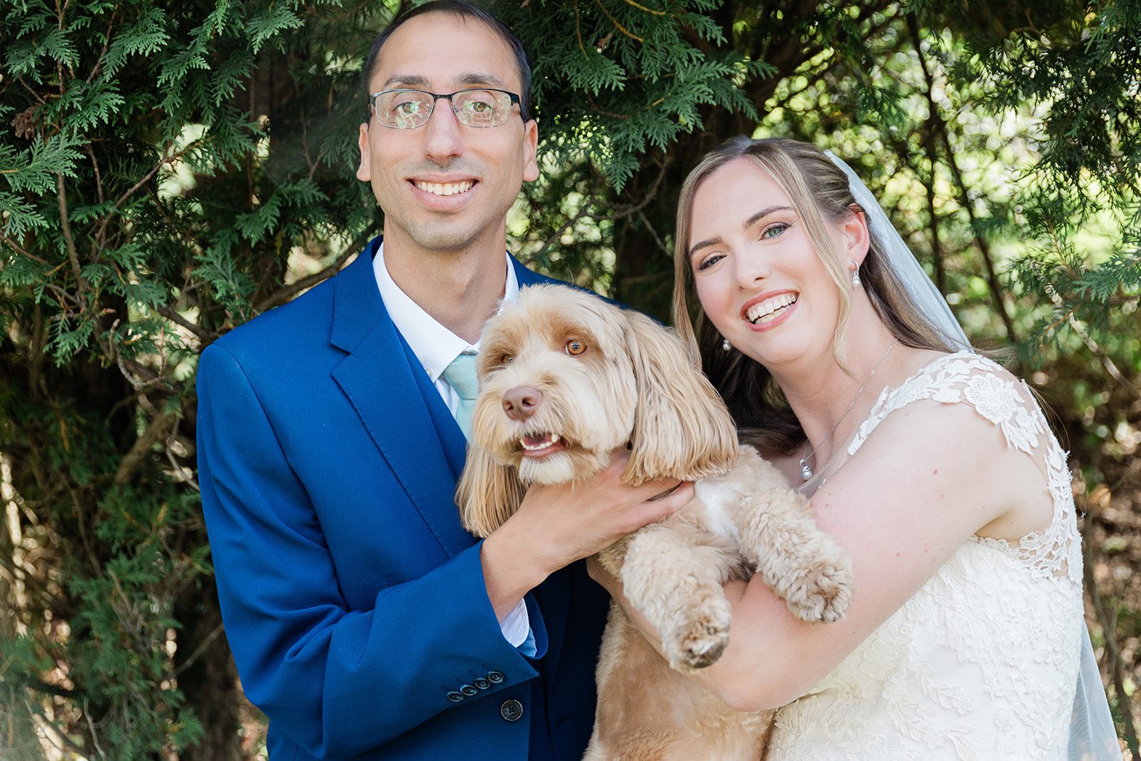 Couple holding their dog Couple holding their dog
