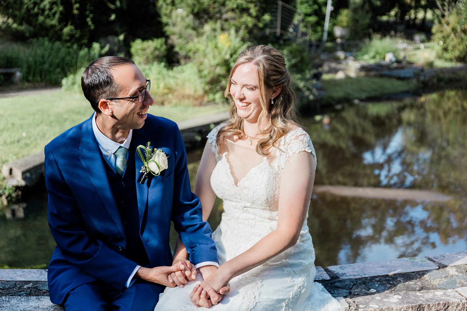 Bride and groom smiling by the pond, captured by New York wedding photographers from Original Weddings at Travelers Rest Bride and groom smiling by the pond, captured by New York wedding photographers from Original Weddings at Travelers Rest