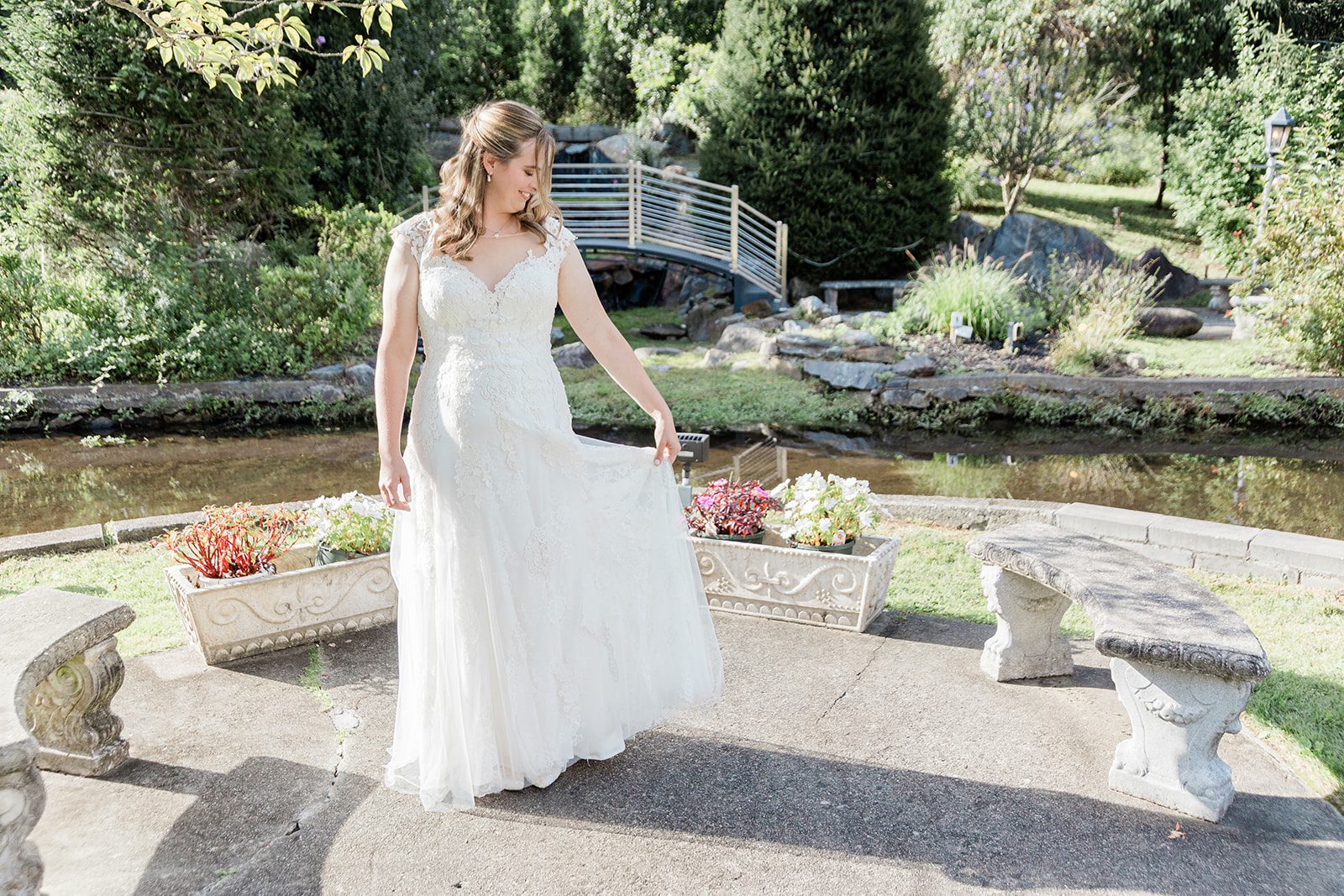 Bride standing by the garden path Bride standing by the garden path