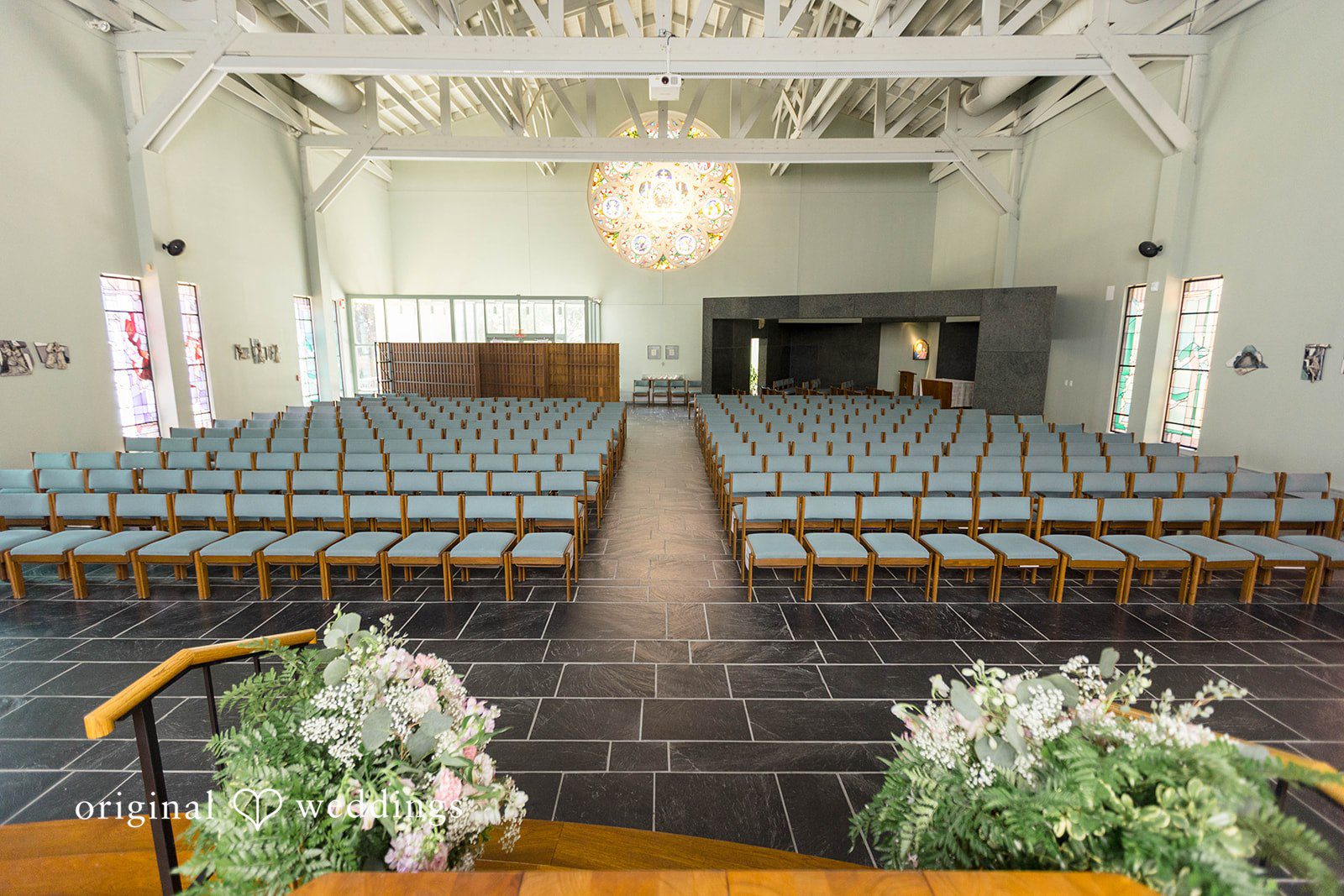 Ceremony room set with white chairs and flowers at Tremont Cityside Ballroom