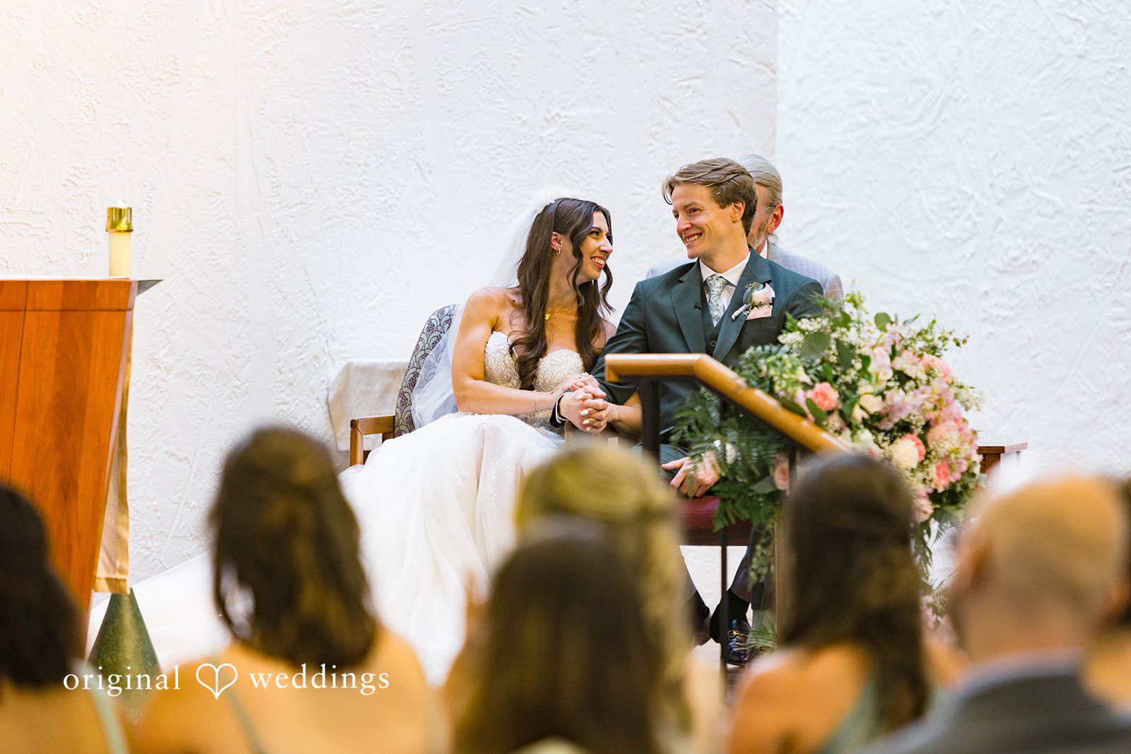 Couple during the ceremony with guests watching at Tremont Cityside Ballroom