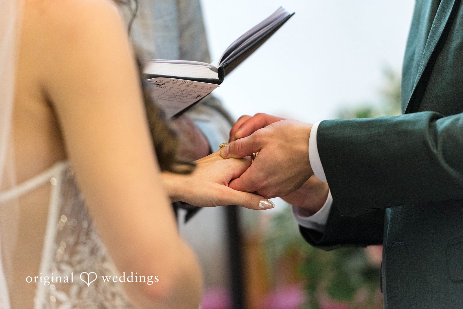 Groom placing the ring on the bride's finger