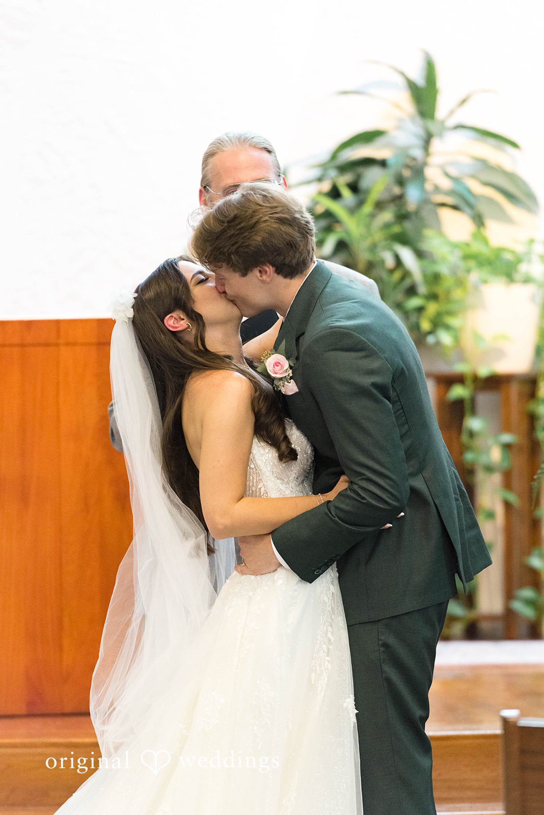 Couple kissing near a window