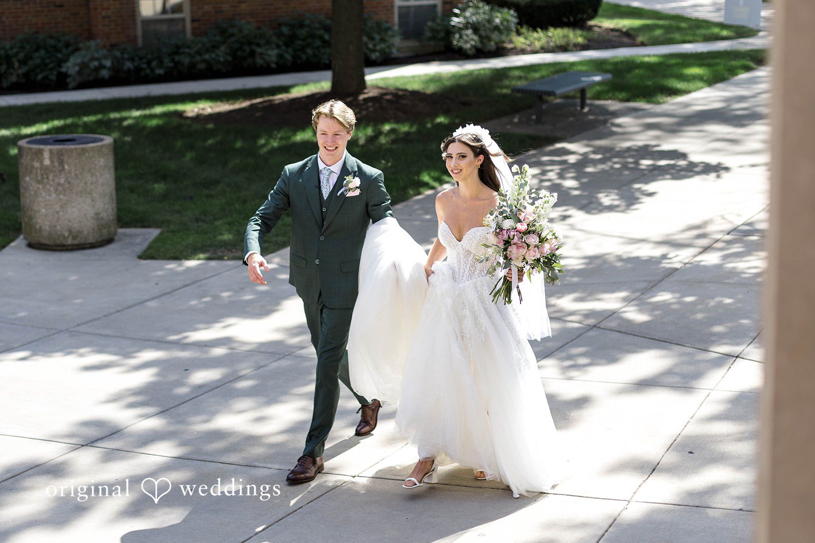 Bride and groom walking along a path