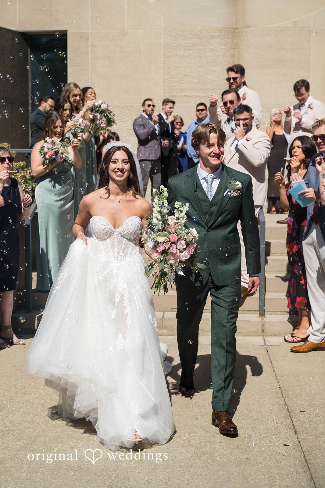 Newlyweds walking up the aisle with the wedding party