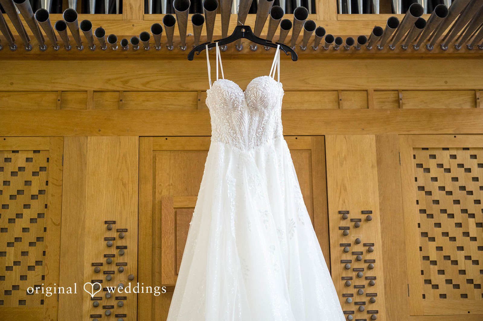 Wedding dress hanging on a wooden wall by Cleveland wedding photographers at Tremont Cityside Ballroom