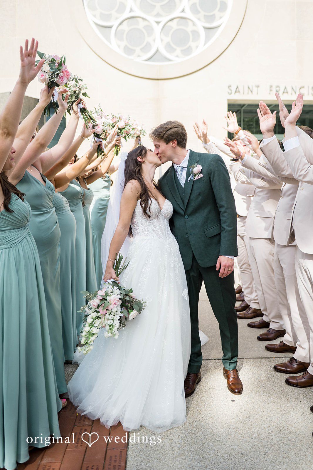 Couple meeting at the end of the aisle beside the bridesmaids at Tremont Cityside Ballroom