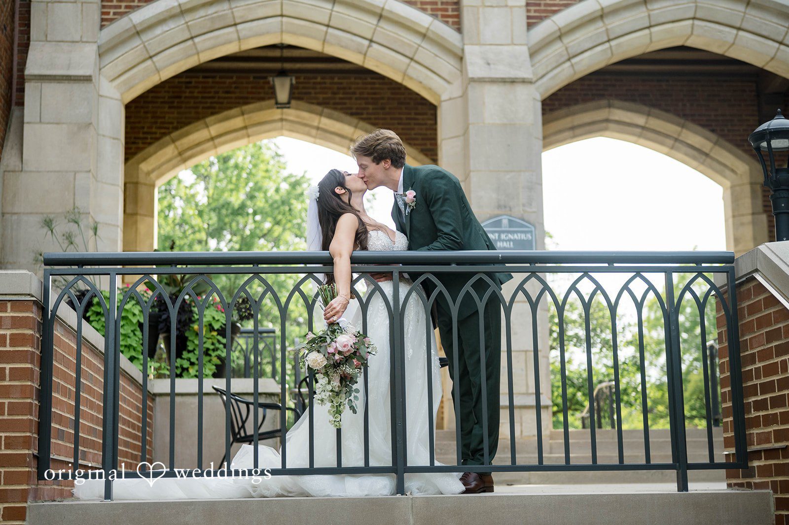 Couple kissing on a stone balcony