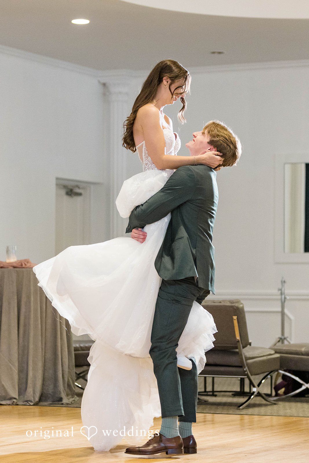 Groom lifting the bride on the dance floor