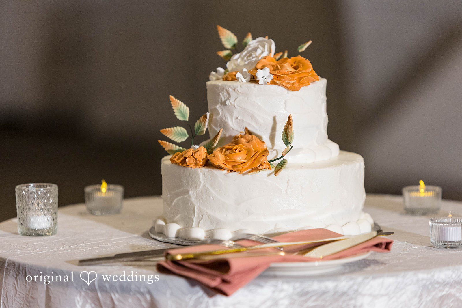 White wedding cake with orange flowers