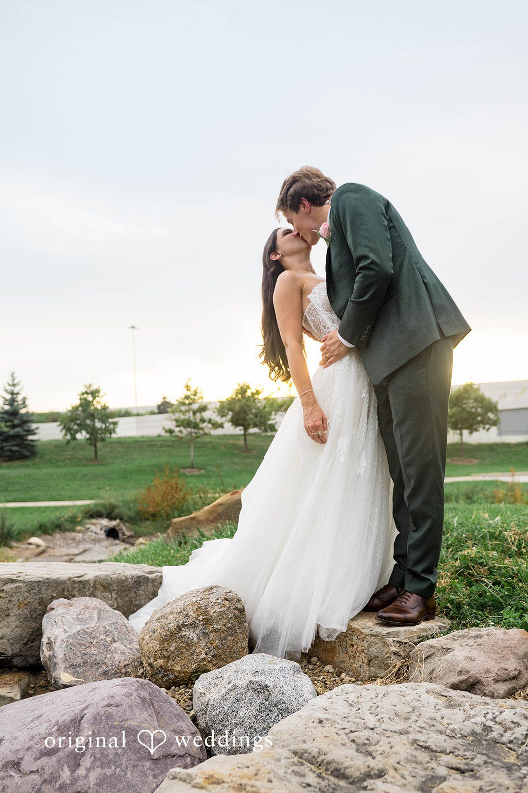 Couple embracing among the garden rocks
