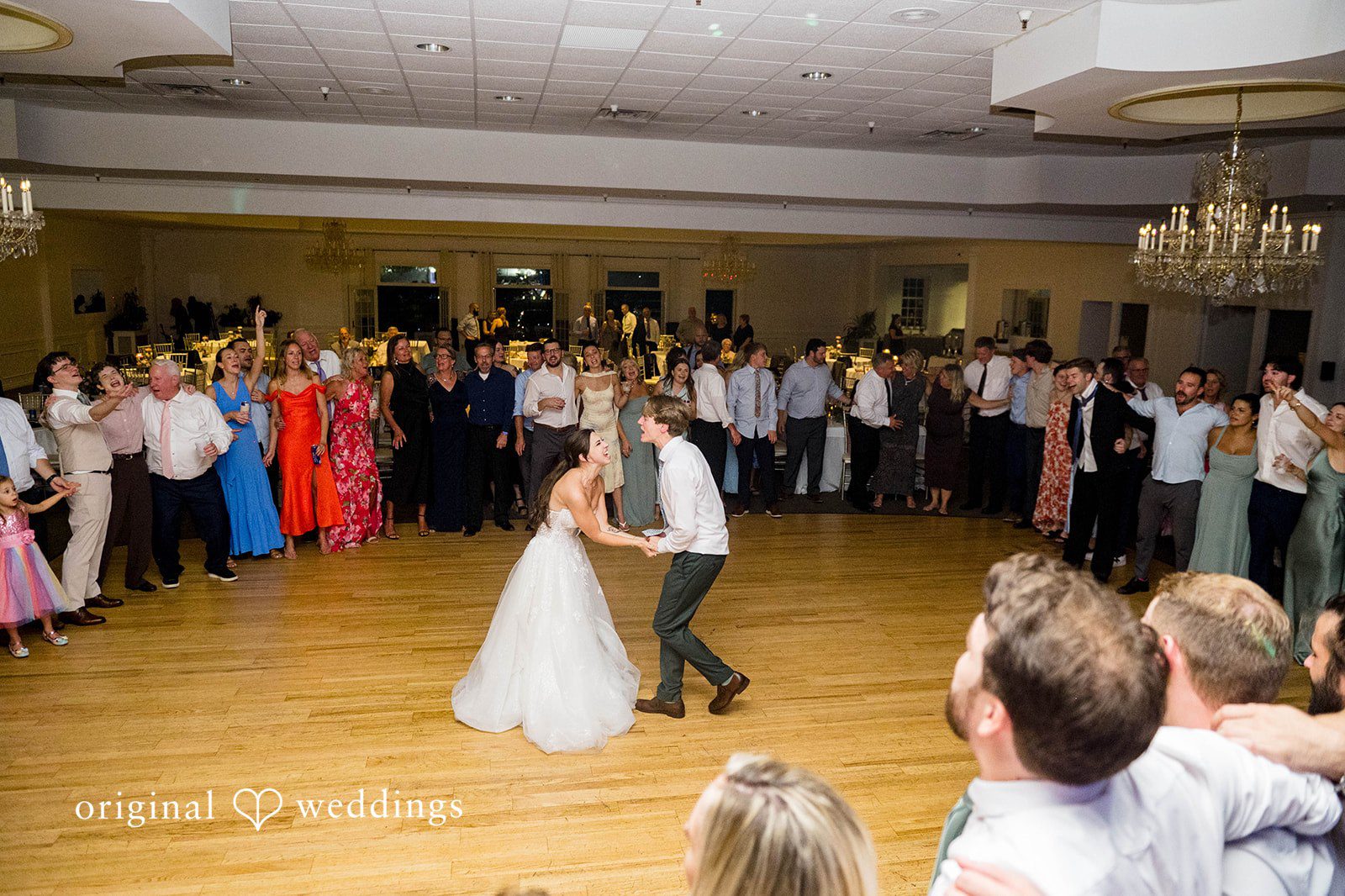 Guests circling the couple on the dance floor