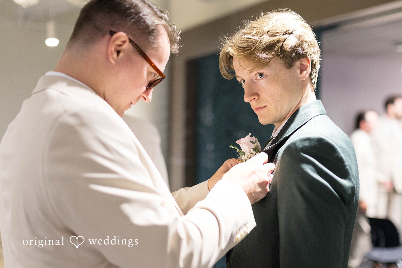 Groom getting his boutonniere pinned at Tremont Cityside Ballroom