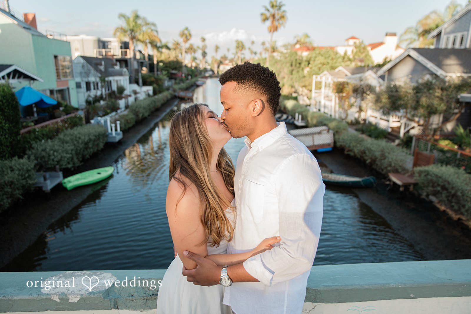 Christine + David David kissing Christine on the footbridge at Venice Canals