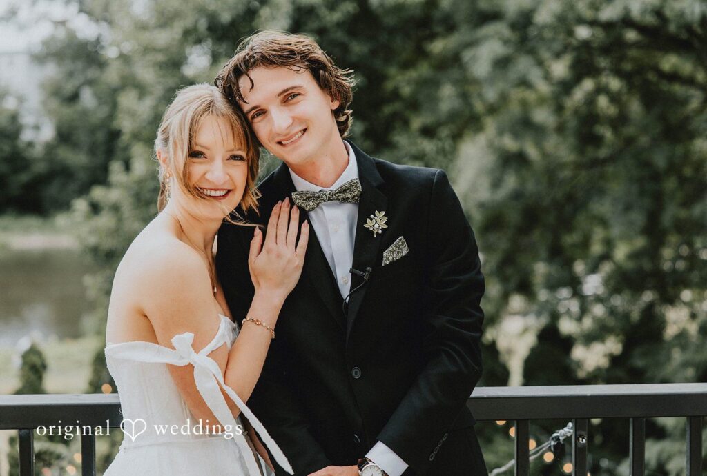 Bride and groom smiling together on a balcony, captured by Milwaukee wedding photographers from Original Weddings at Veterans Terrace