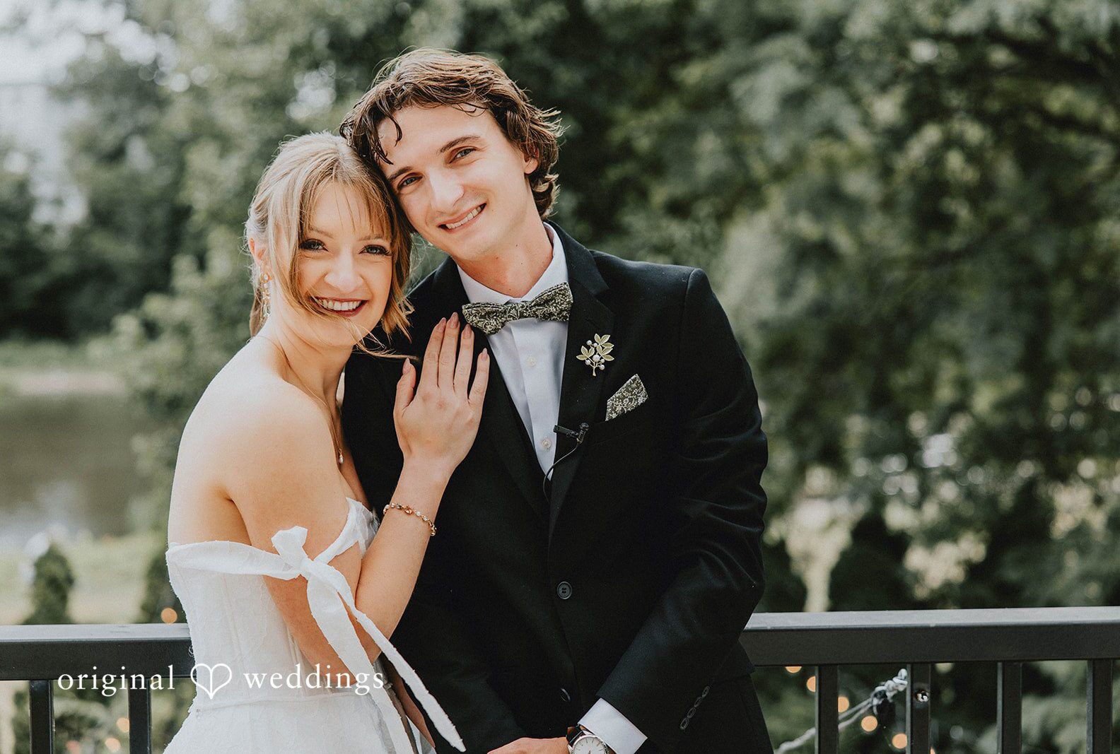 Bride and groom smiling together on a balcony, captured by Milwaukee wedding photographers from Original Weddings at Veterans Terrace