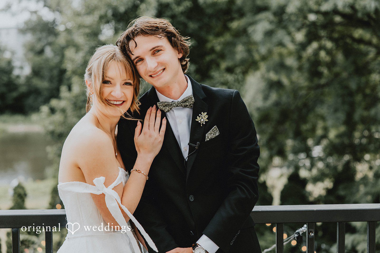 Grace + Andre Bride and groom smiling together on a balcony, captured by Milwaukee wedding photographers from Original Weddings at Veterans Terrace