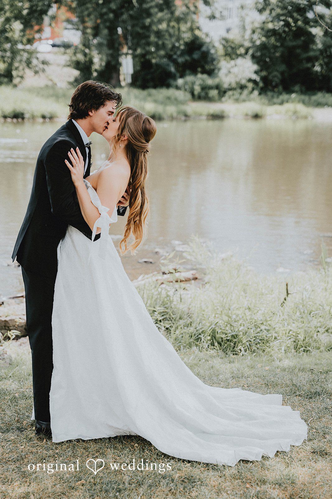 Grace + Andre Bride and groom kissing near the lake