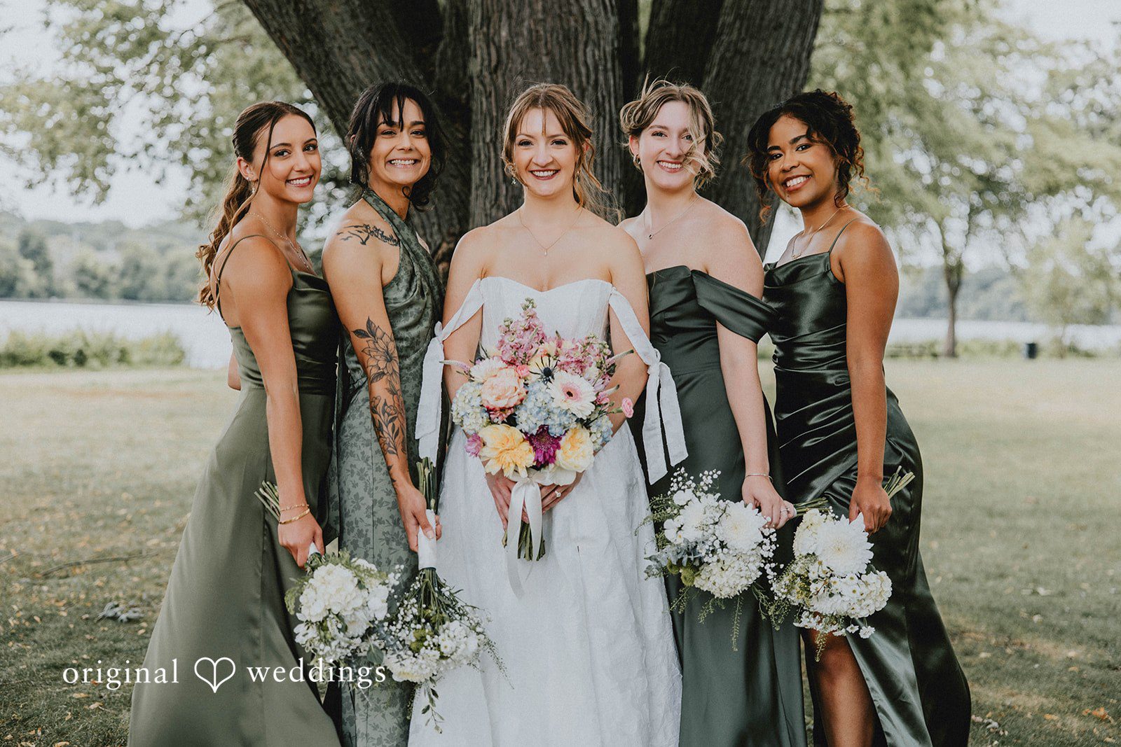 Grace + Andre Bride standing with her bridesmaids in green dresses