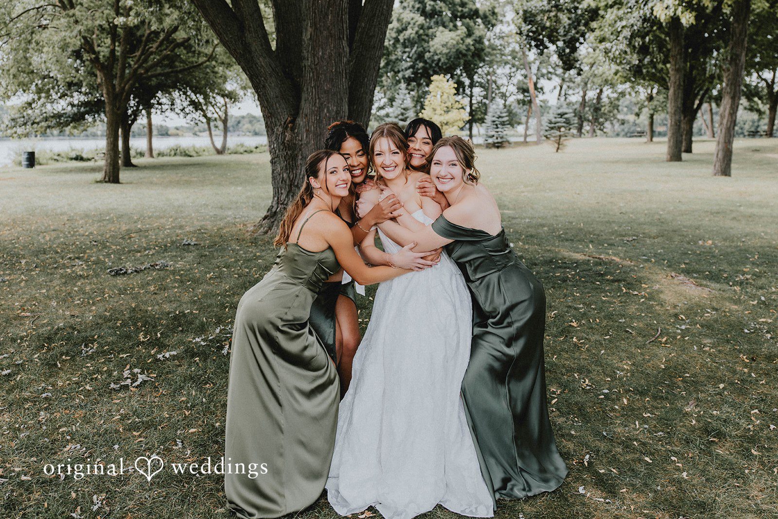 Grace + Andre Bride laughing with her bridesmaids in the park