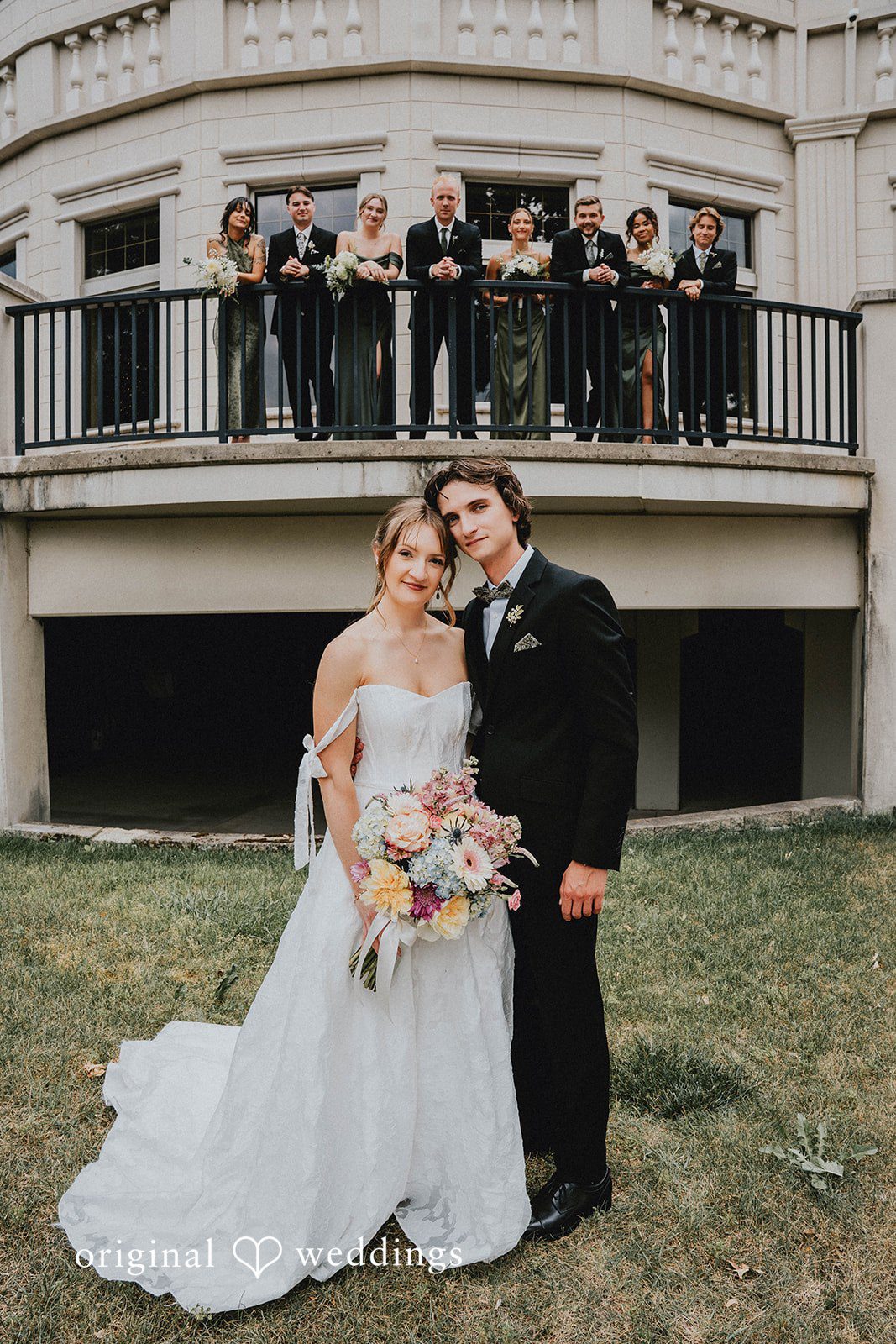Grace + Andre Bride and groom standing on the lawn below a balcony