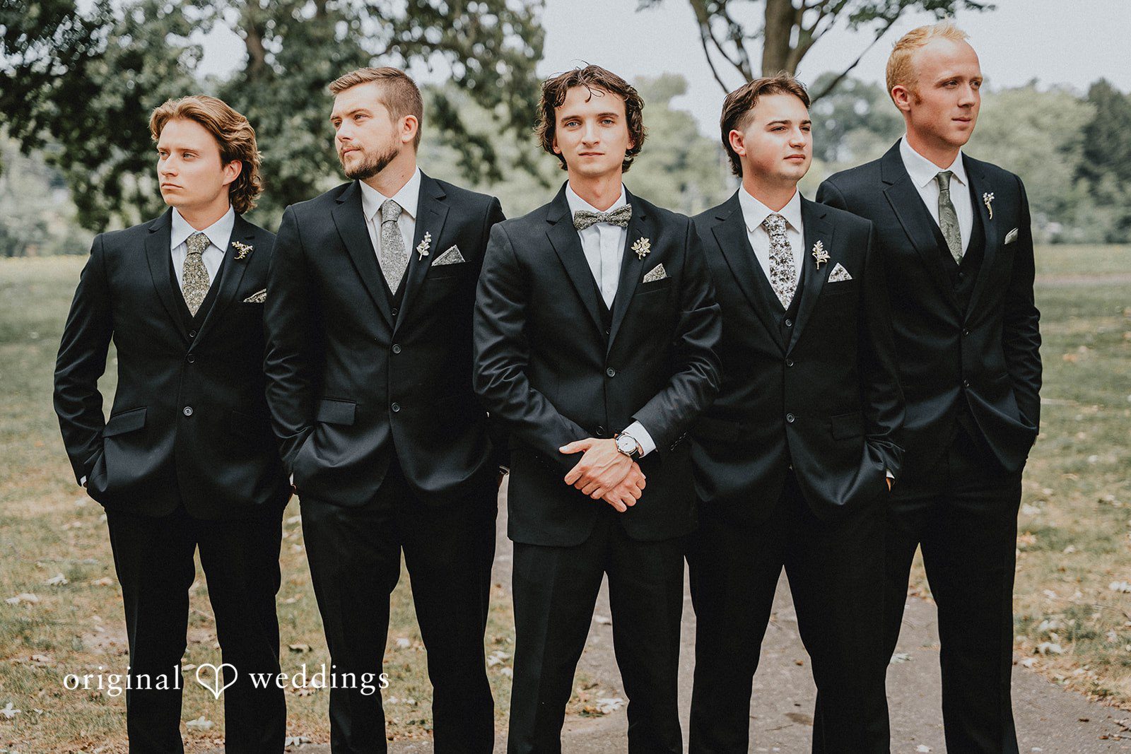 Grace + Andre Groom standing with his groomsmen outdoors