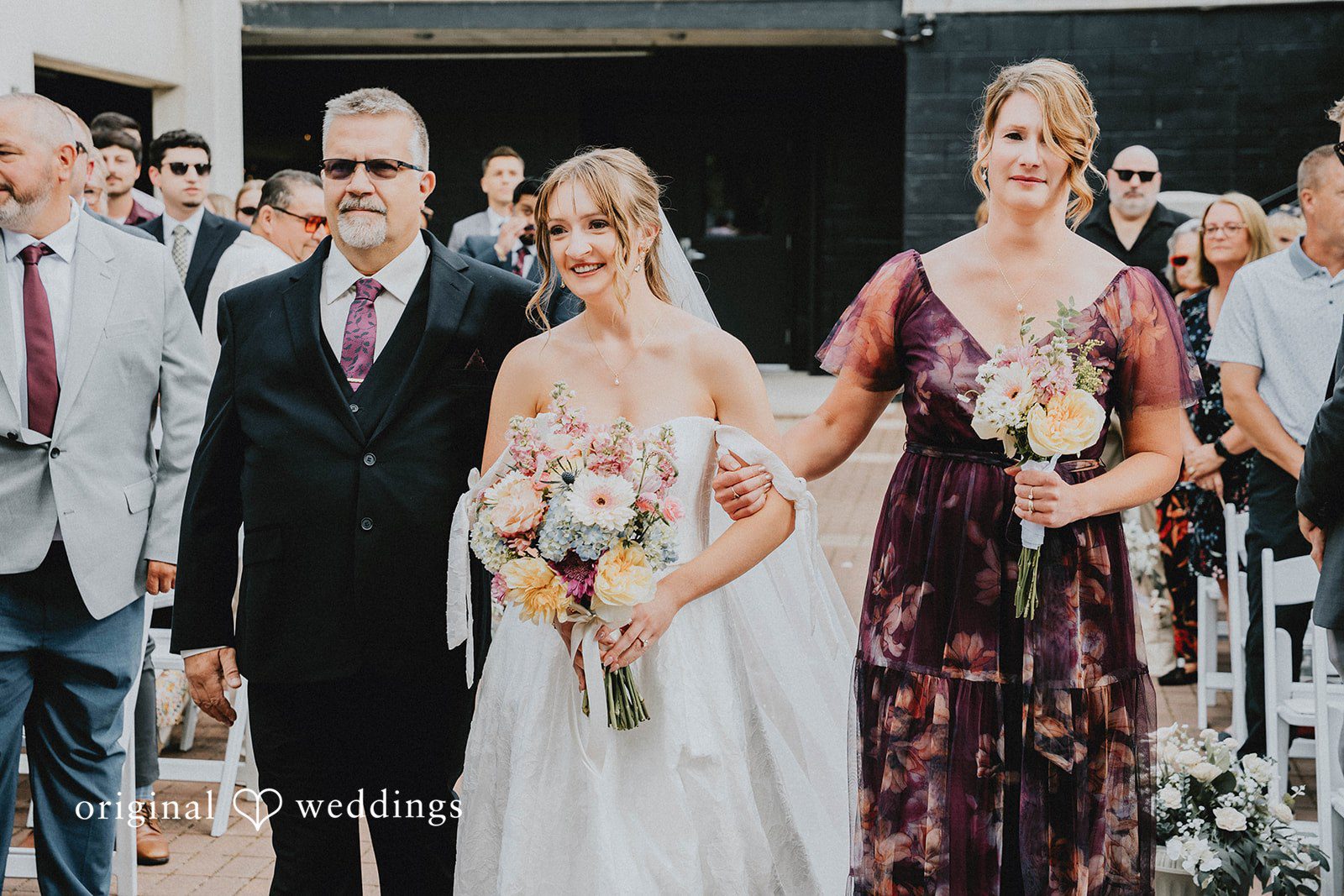 Grace + Andre Bride walking down the aisle with her parents