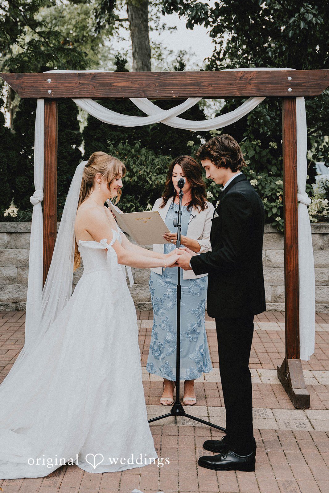 Grace + Andre Bride and groom standing under the ceremony arch
