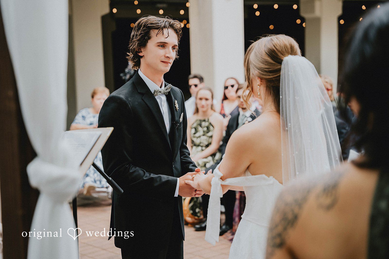Grace + Andre Bride and groom holding hands during the wedding ceremony