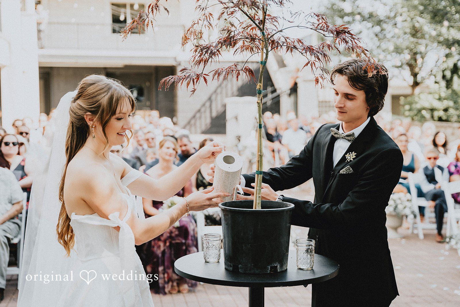 Grace + Andre Bride and groom sharing a moment at a table outdoors