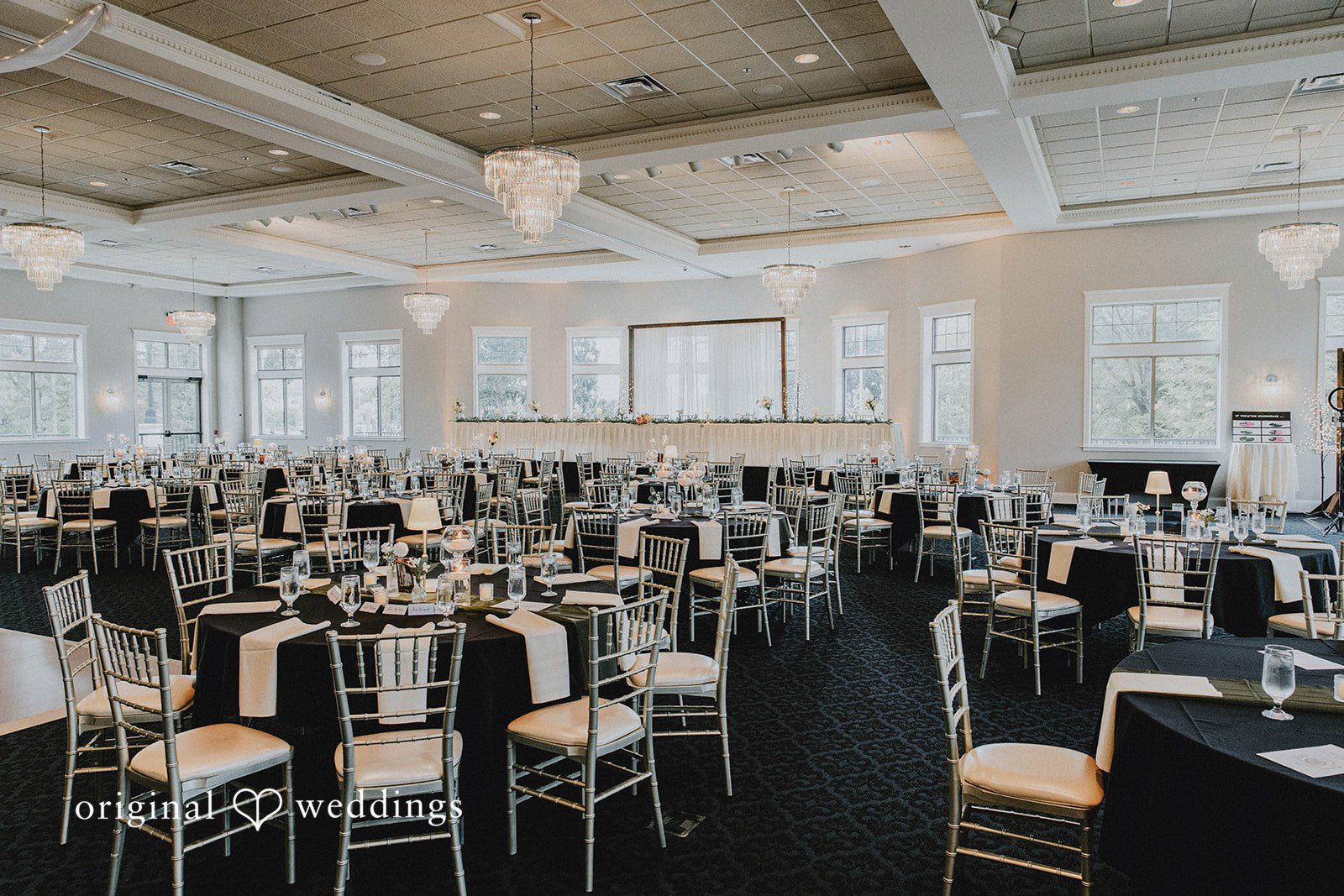 Grace + Andre Reception tables set up inside the Veterans Terrace ballroom