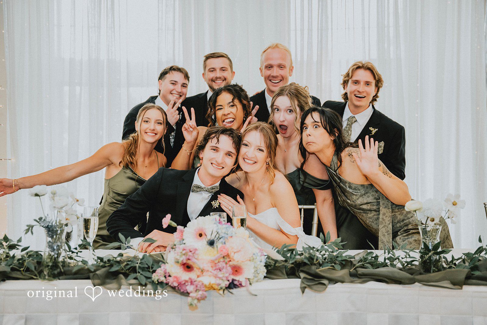 Grace + Andre Wedding party posing together at the head table
