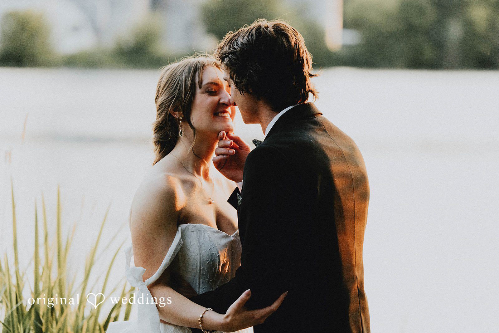 Grace + Andre Bride and groom sharing a close moment by the lake