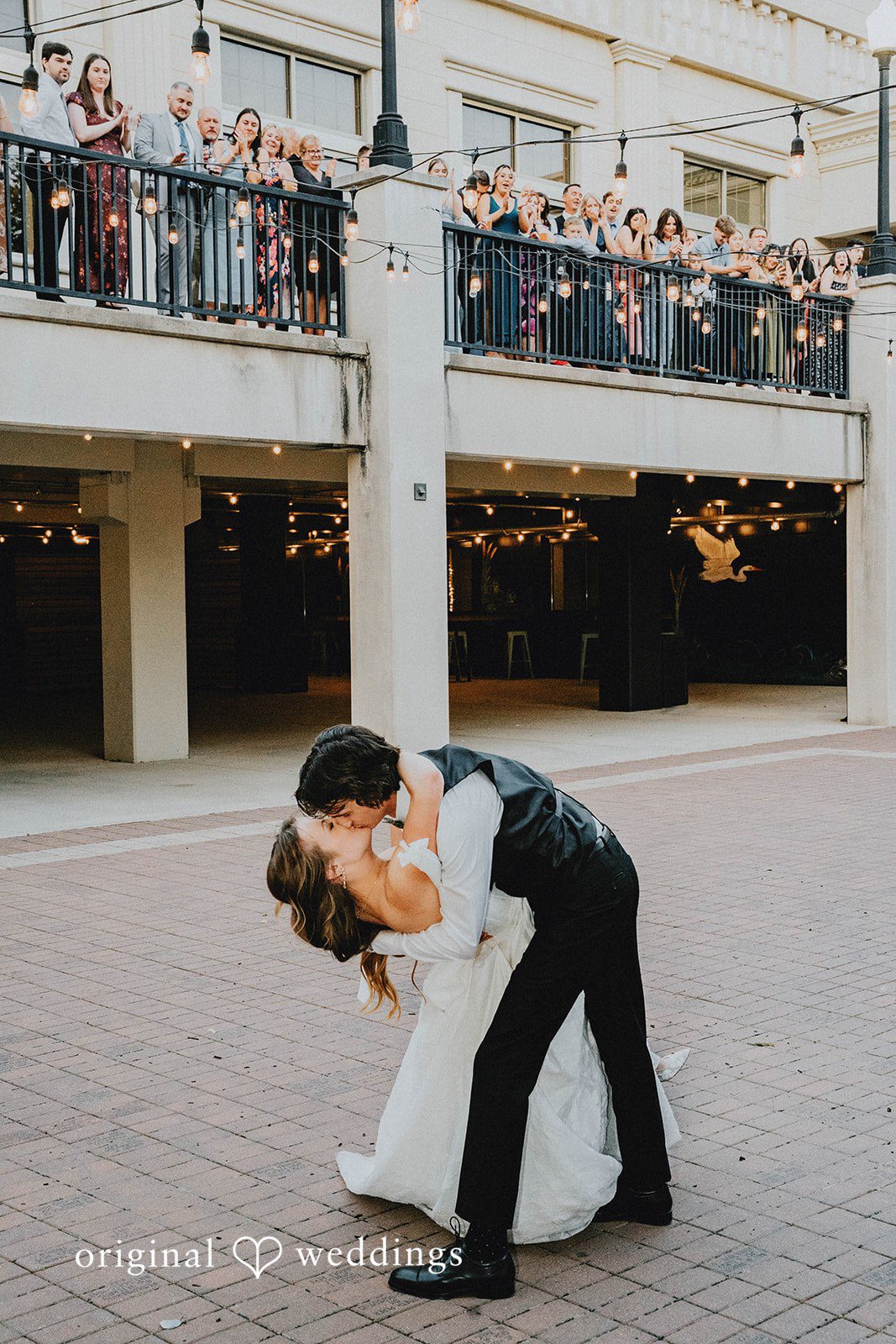 Grace + Andre Groom dipping the bride for a kiss on the terrace at Veterans Terrace