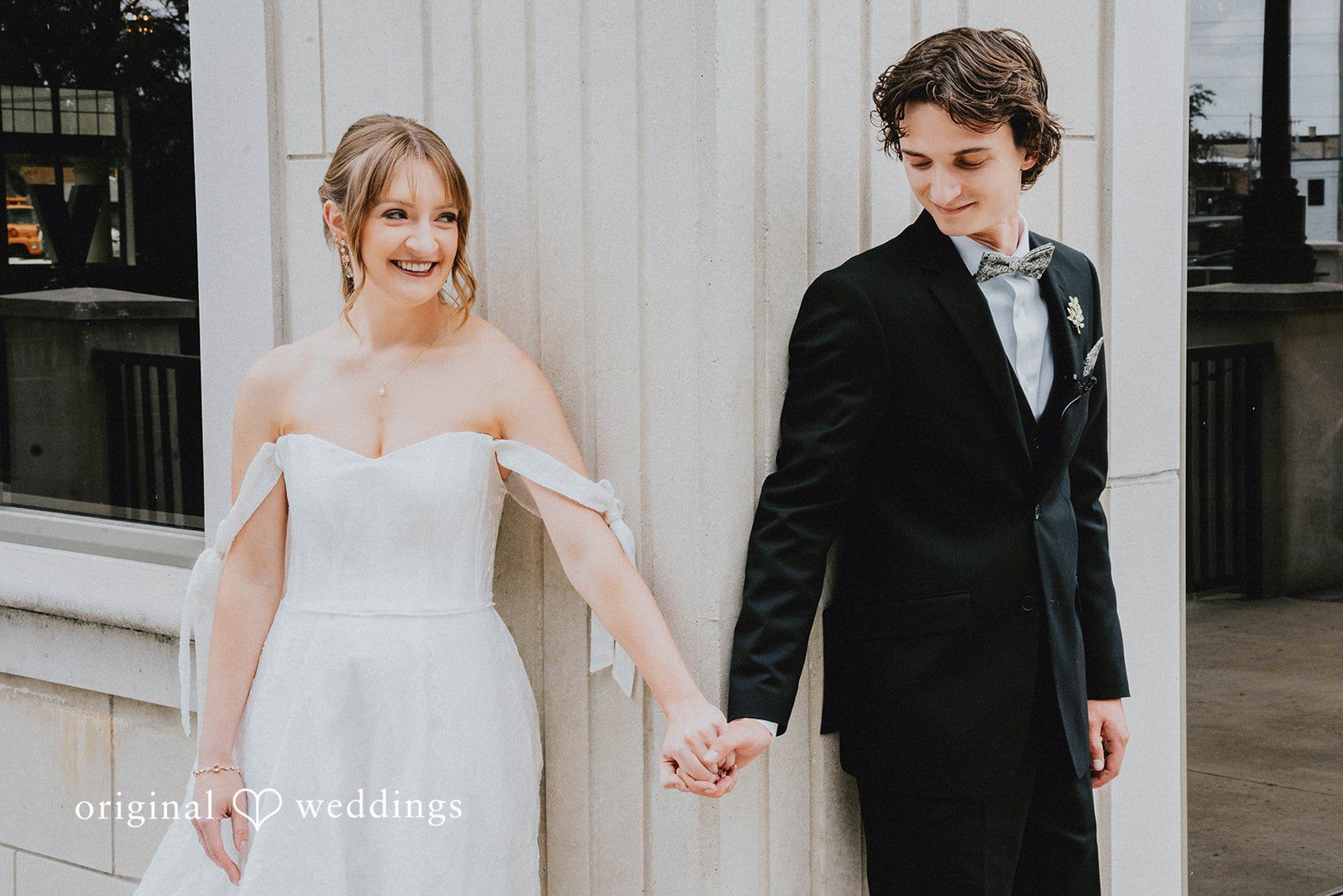 Grace + Andre Bride and groom holding hands indoors