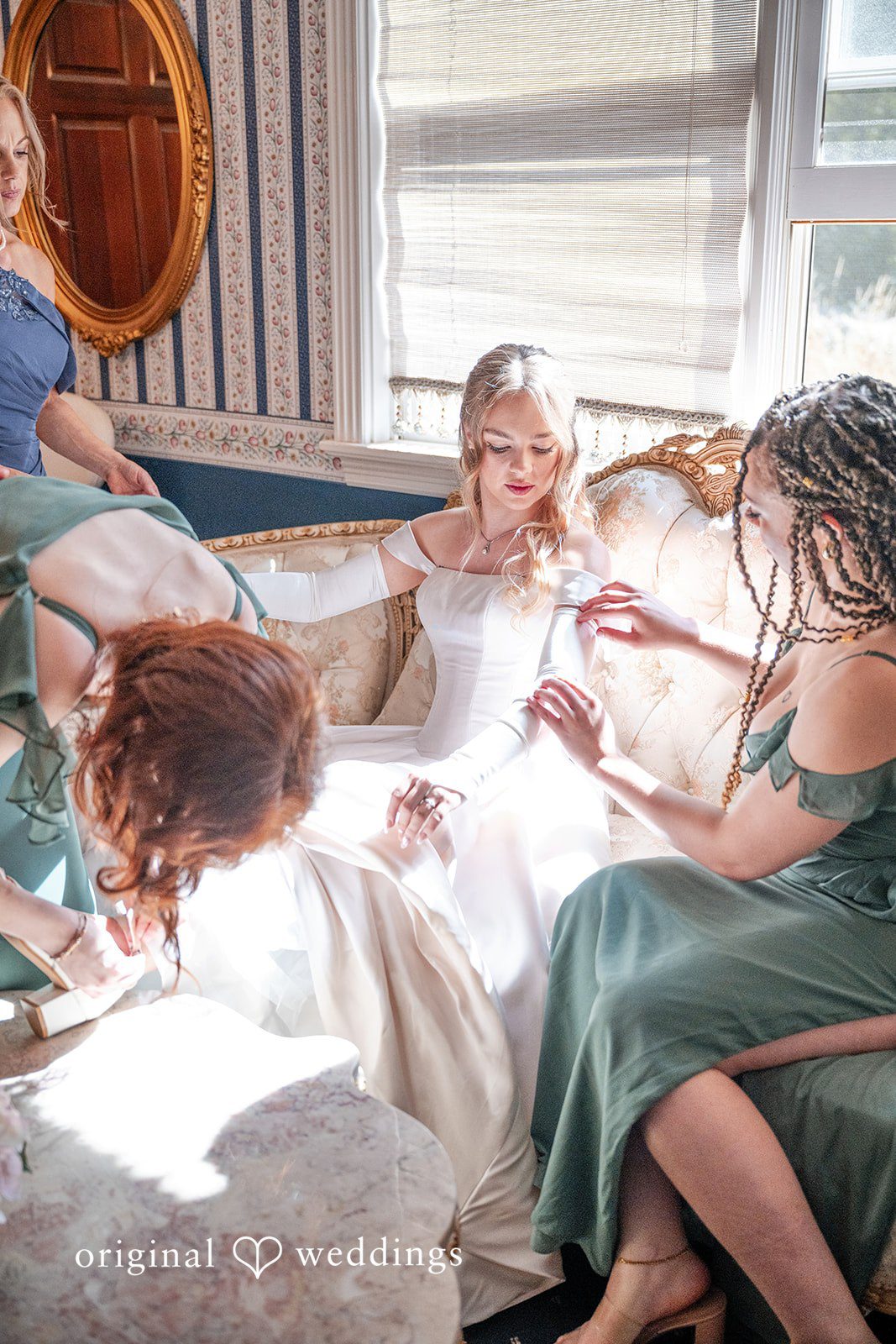 Kylie + Reymundo Bridesmaids laughing with the bride while getting ready