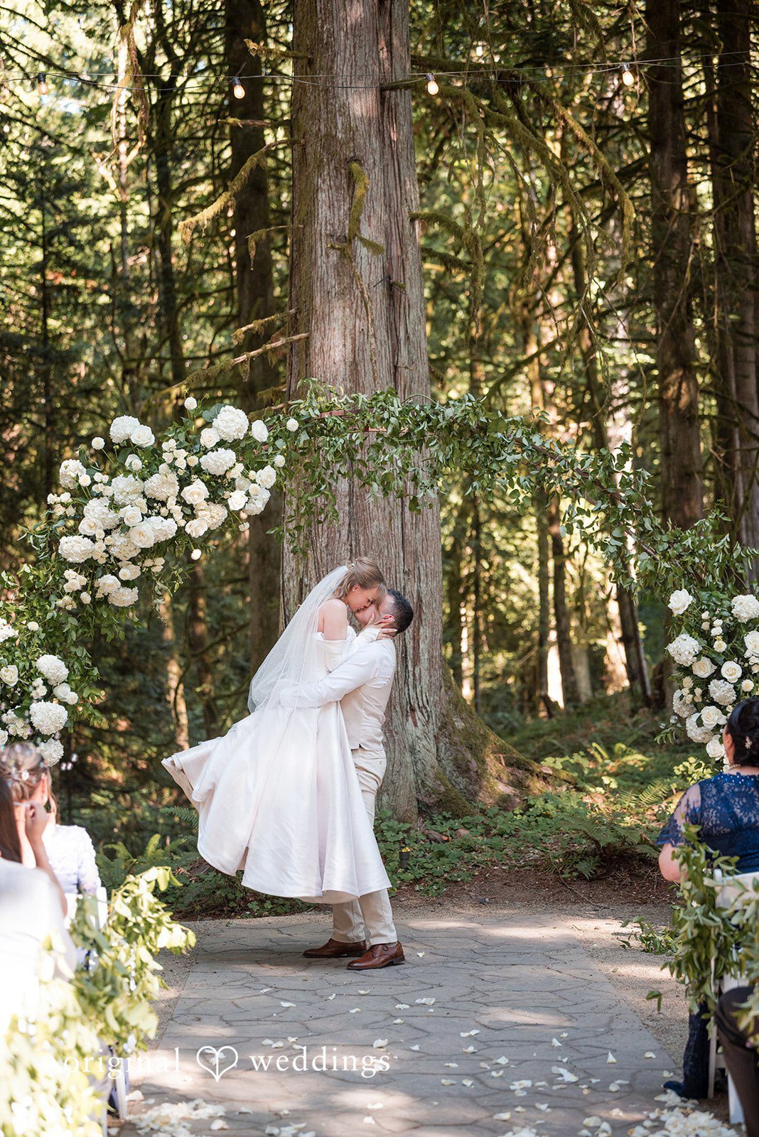 Kylie + Reymundo Couple standing among tall trees at Victorian Vineyard