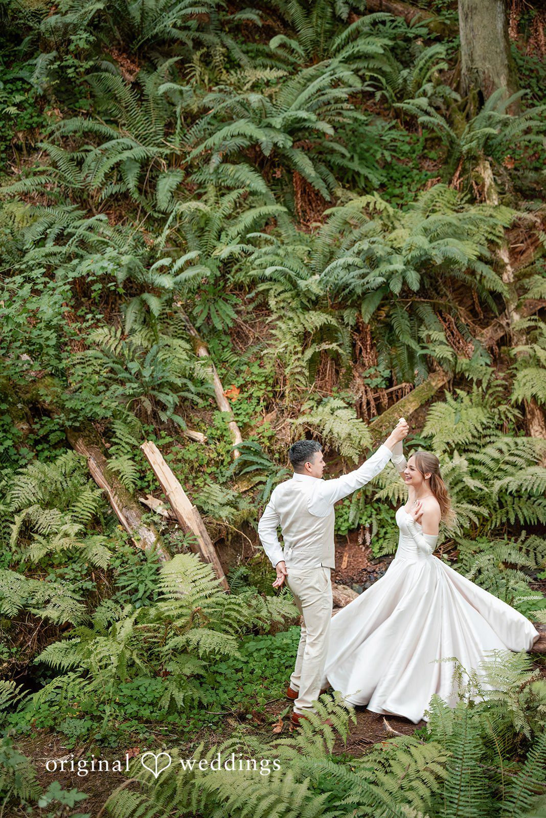 Kylie + Reymundo Groom spinning the bride in the fern garden