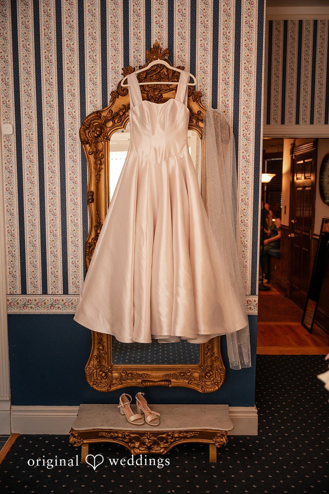 Kylie + Reymundo Kylie's wedding dress hanging before the ceremony